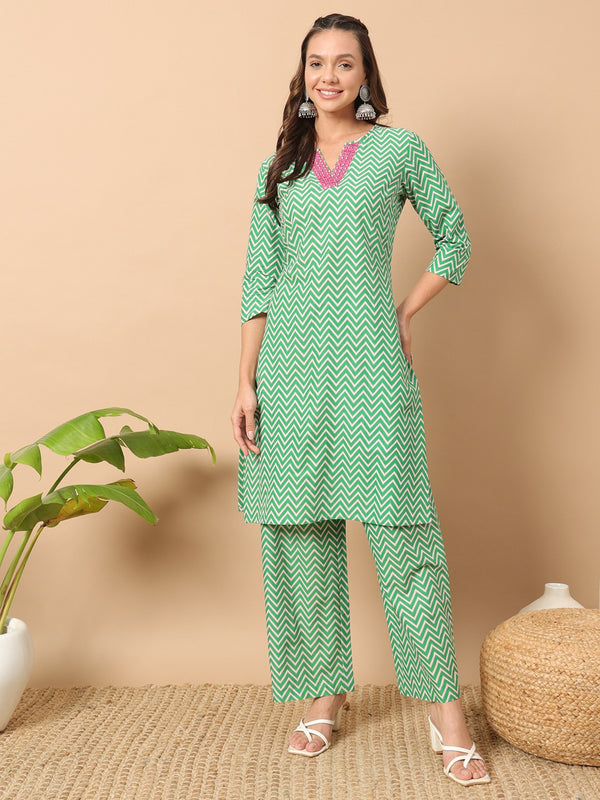 Green suit with mirror work on neckline